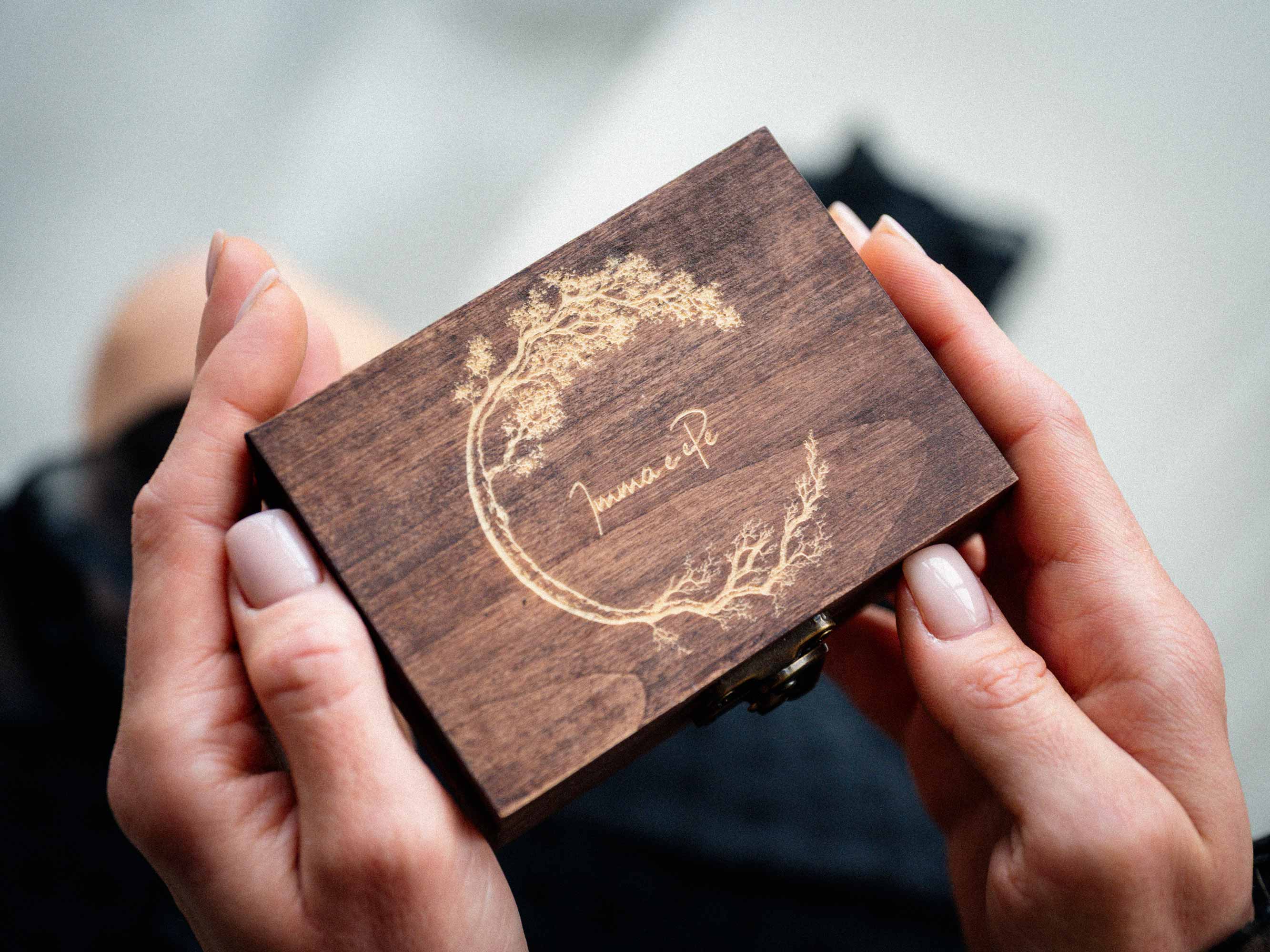 Walnut wooden USB box with light tree engraving held in hands