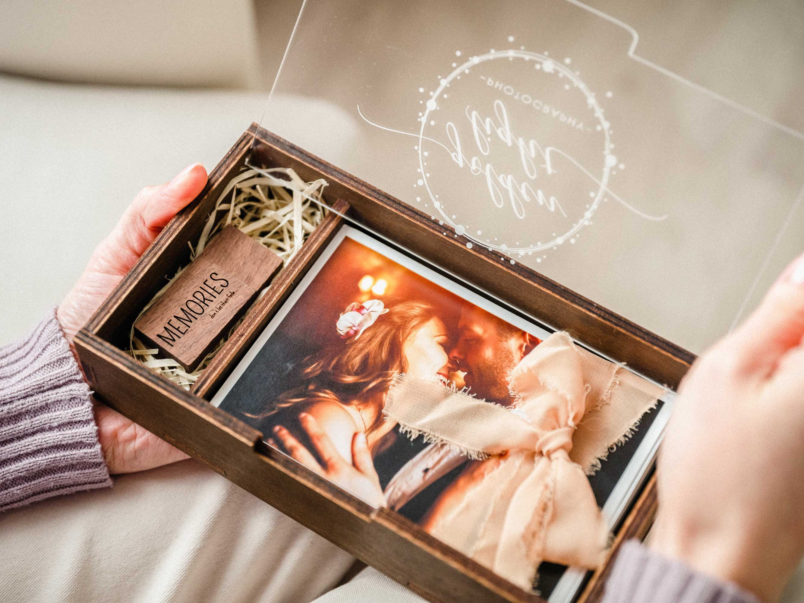 Close-up of a personalized acrylic lid on a wooden wedding photo box