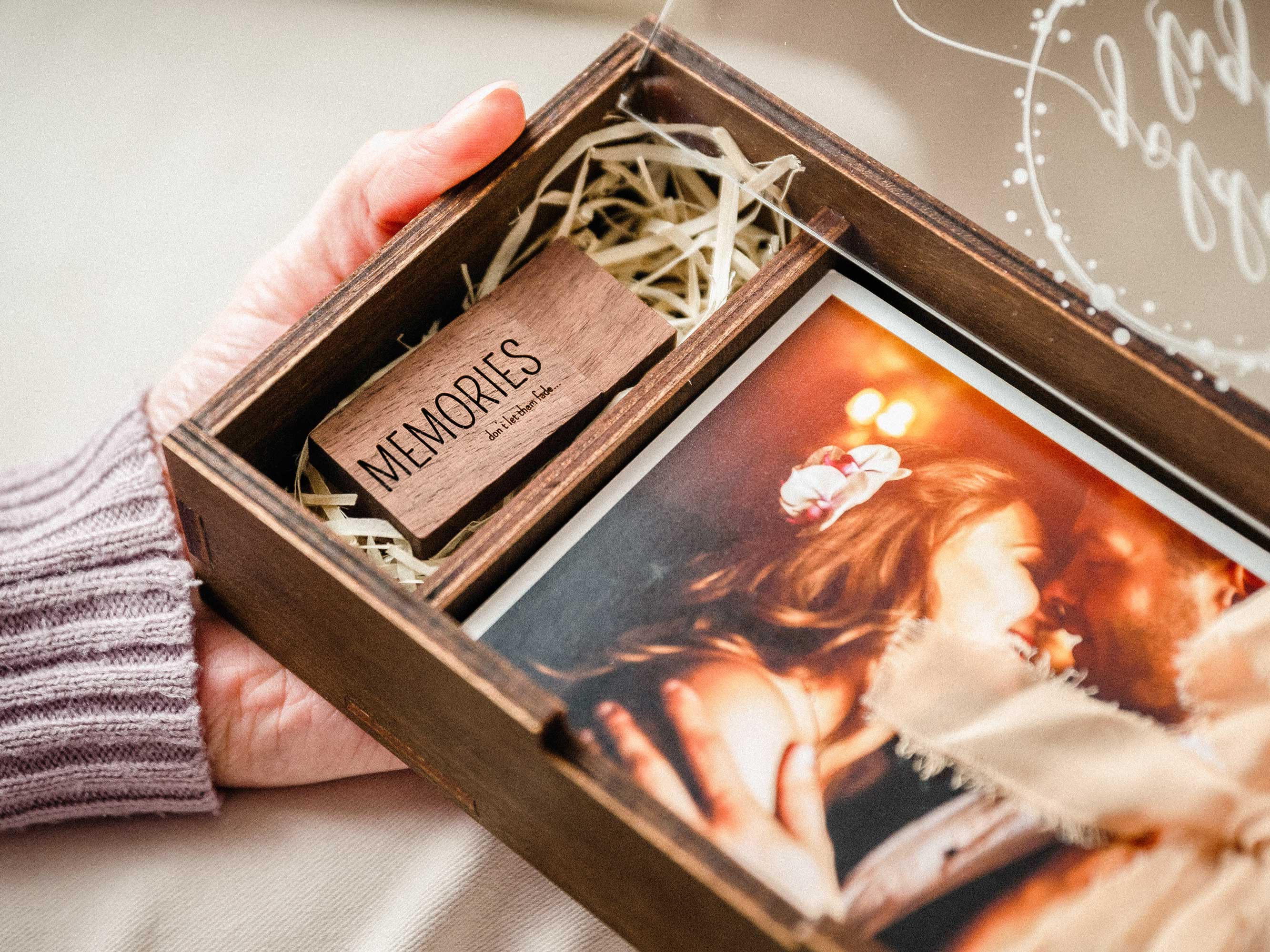 Open wooden photo box with personalized acrylic lid, wooden USB drive, and wedding print