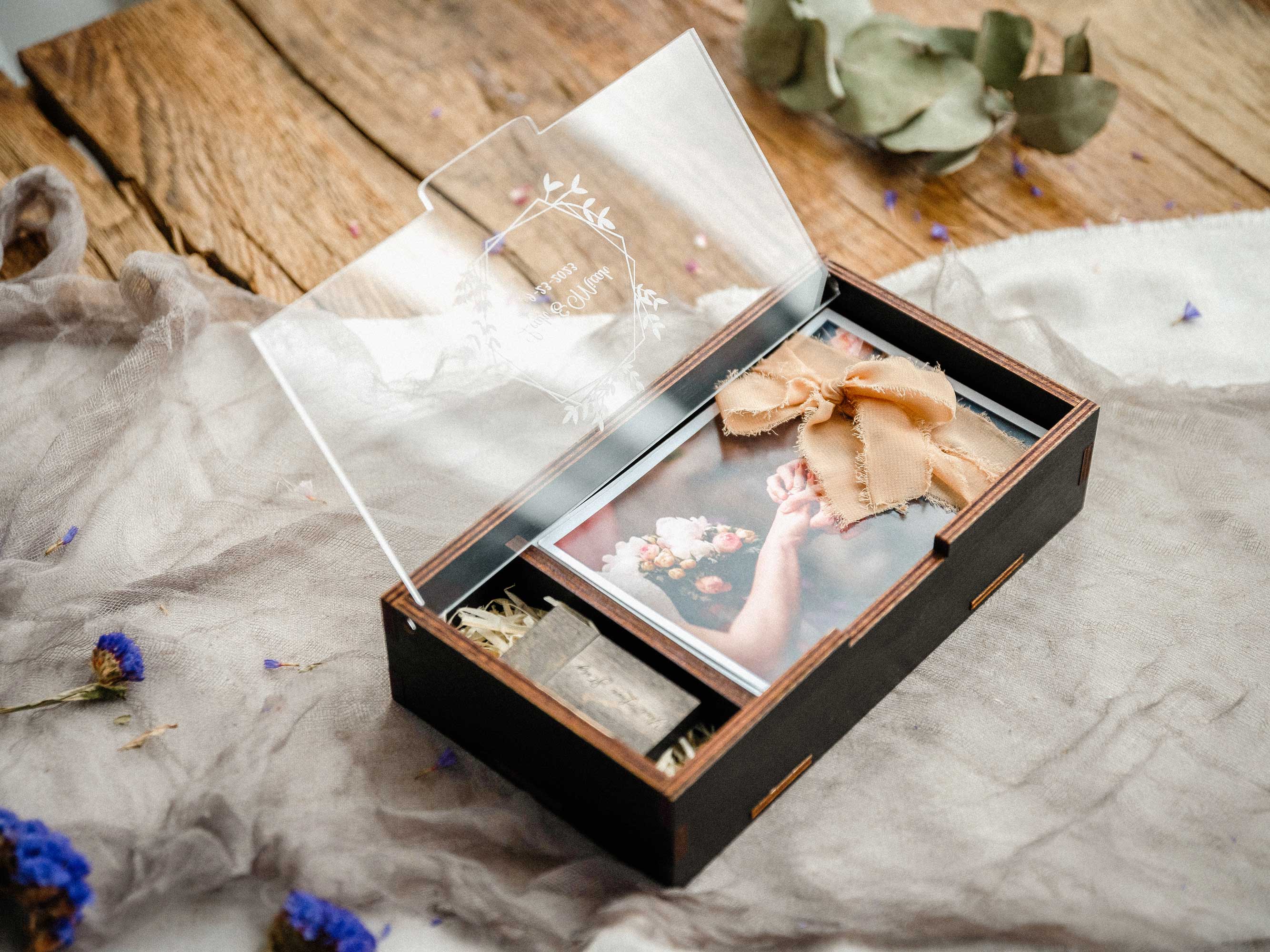 Black wedding photo box with USB compartment, personalized acrylic lid, and printed photos on soft fabric