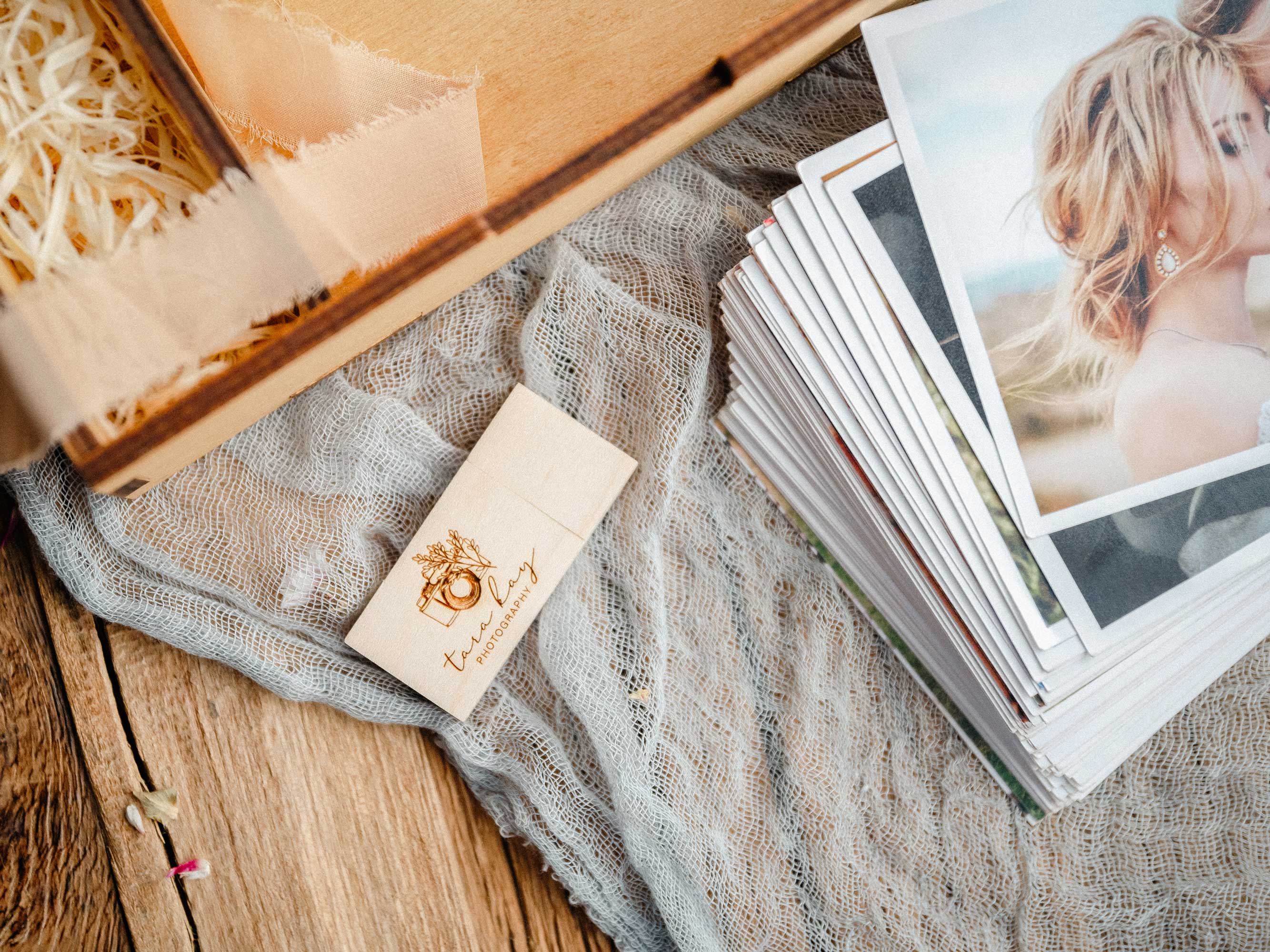 Gold Oak wedding photo box with wooden USB and wedding prints close-up
