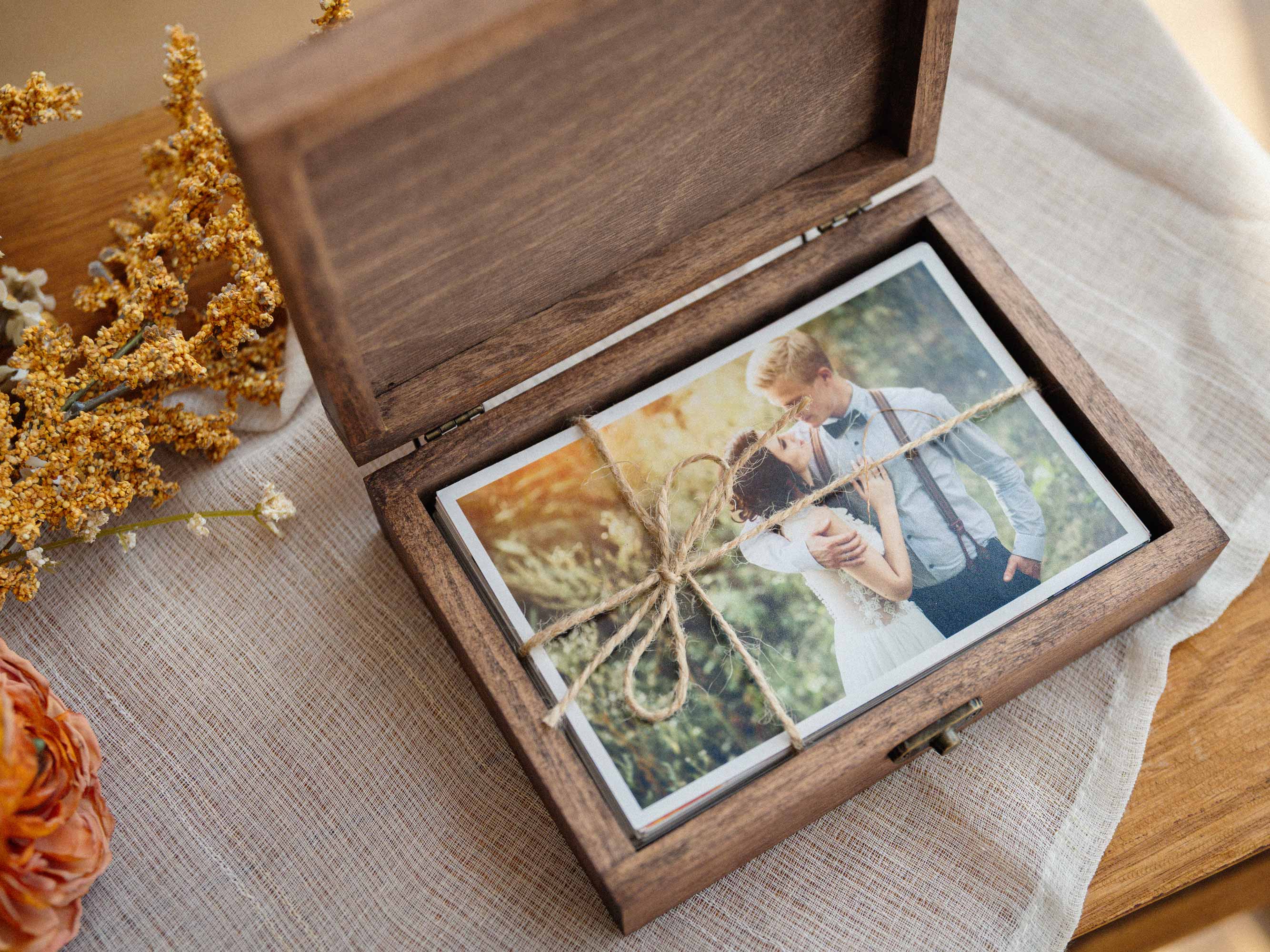 Open Walnut Classic photo box with wedding prints for client presentation