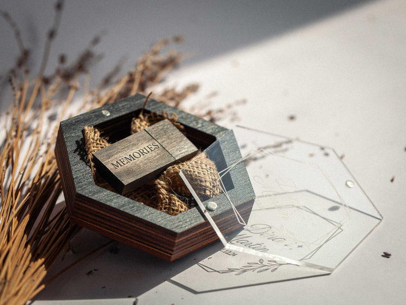 Rustic filler and flash drive inside hexagon black USB wedding box, top view
