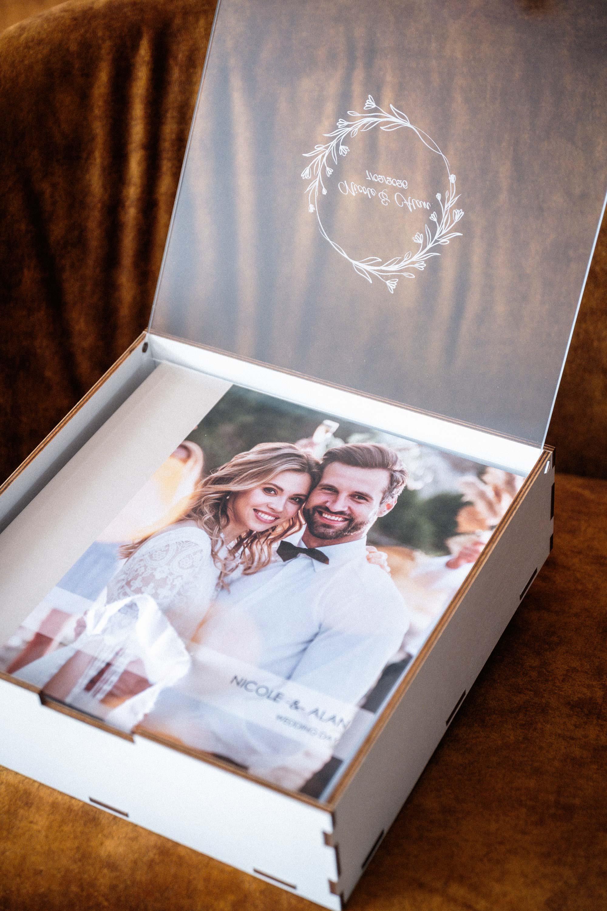 Close-up of engraved acrylic lid on white wooden box for 10x10 photo album