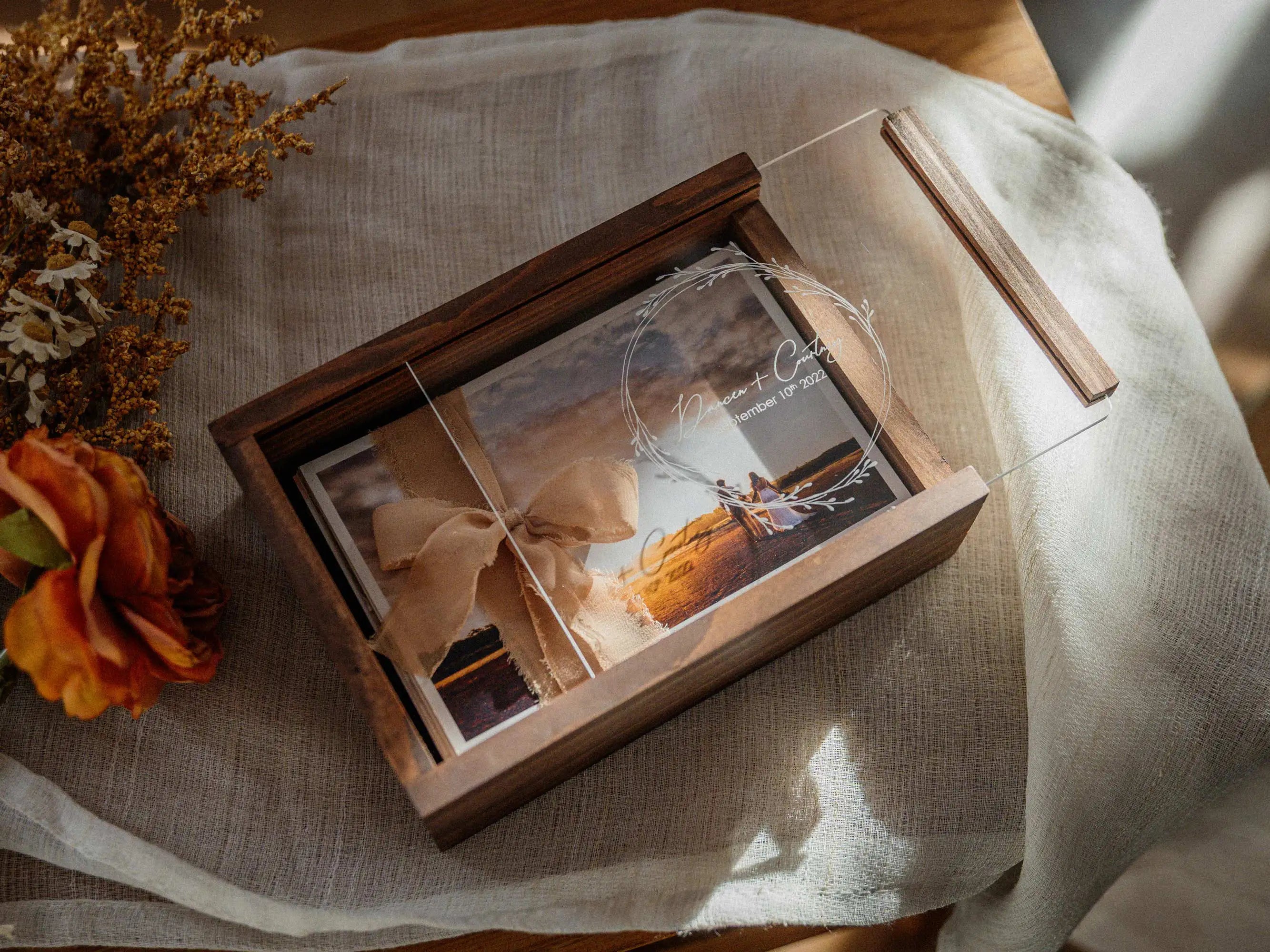 Top view of walnut wooden photo box with acrylic lid and wedding print