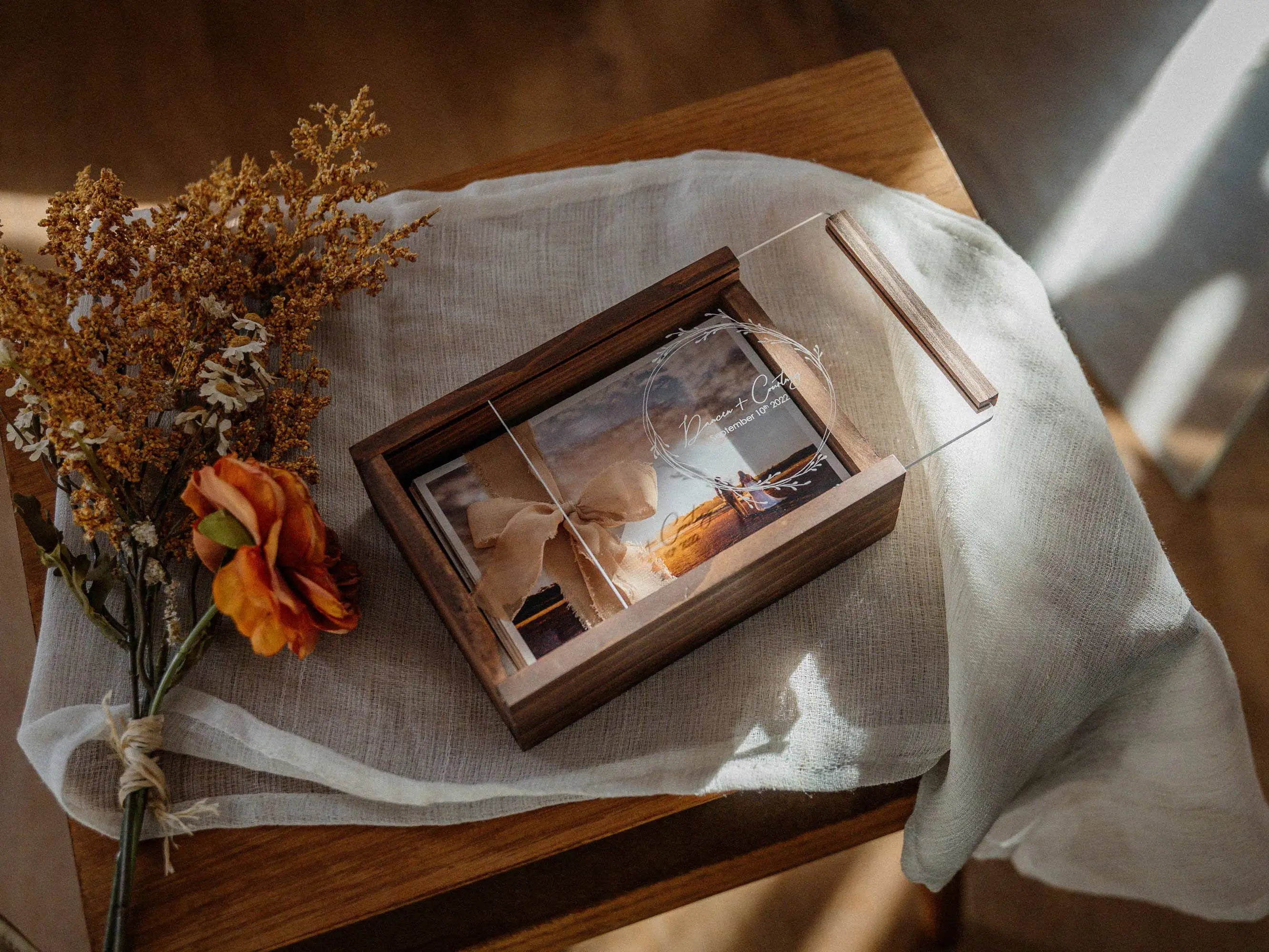 Walnut wooden photo box styled on linen fabric with wedding print inside